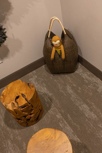 Purse with plush monkey on the floor